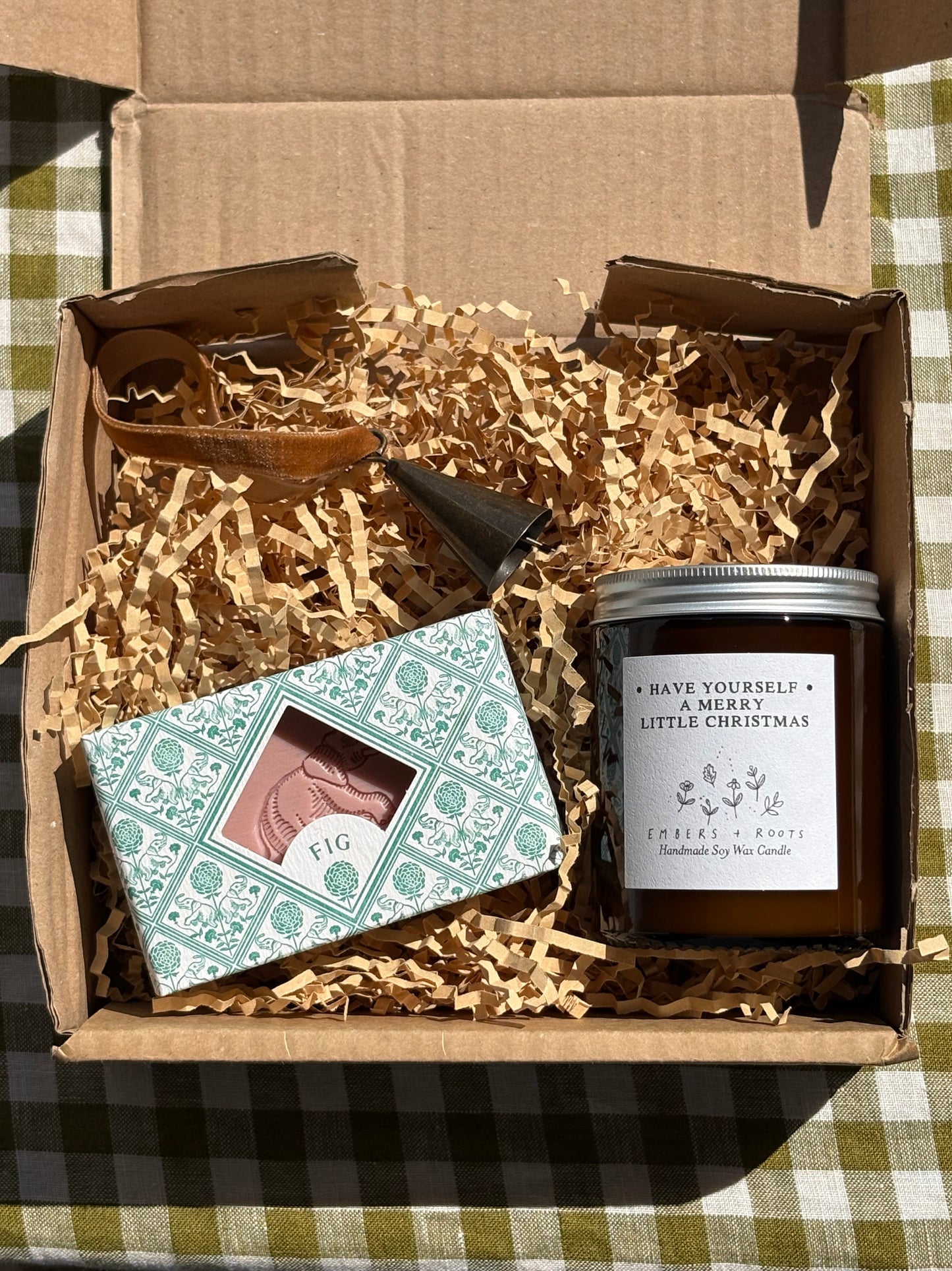 Gift box with a candle, soap and Christmas decorative bell
