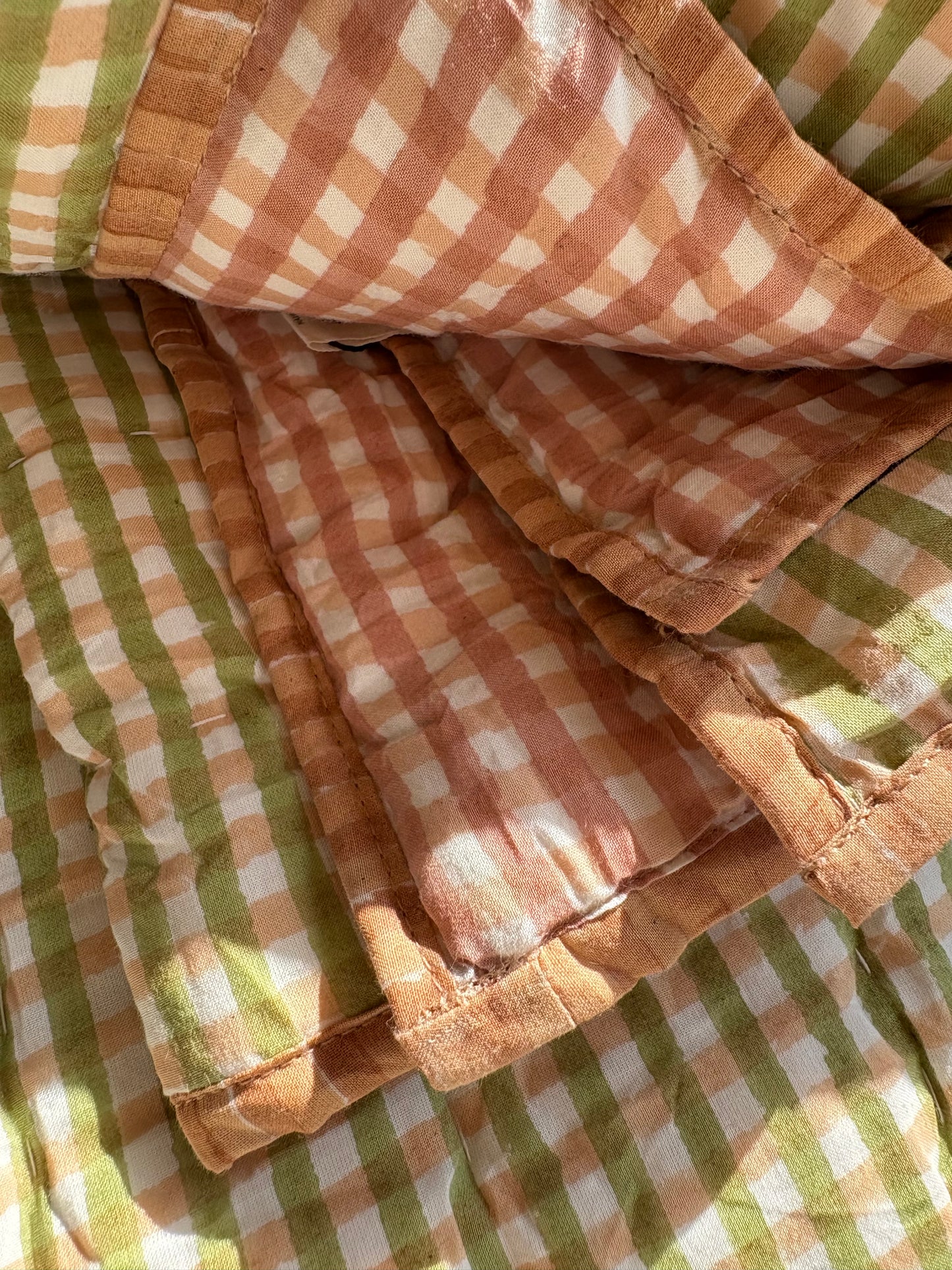 Close-up of a checkered fabric with brown, white, and green colors.