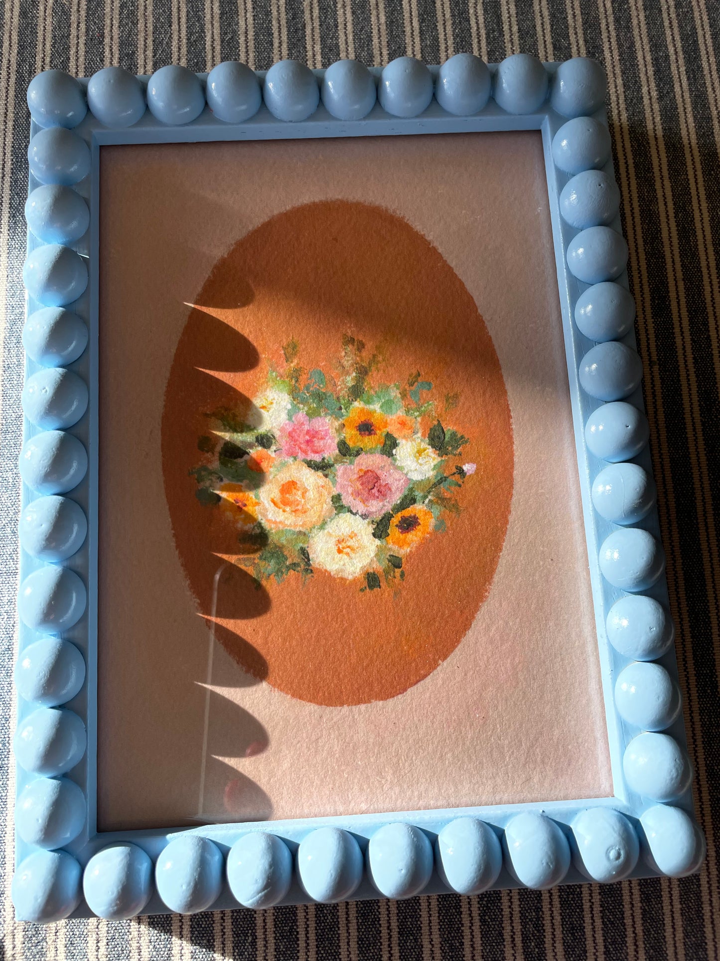 Blue wooden bobbin bobble frame with Brittany Smith wildflower print
